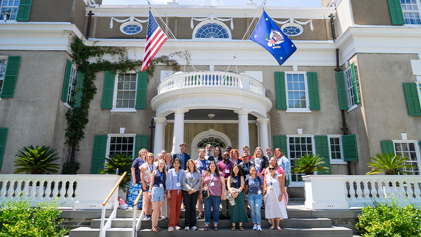 Image of Dr. Woolner and teachers standing outside the FDR home.