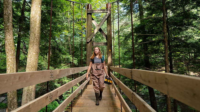 Image of Tarver summer intern Kristen Fitzgibbon hiking to a vernal pool at the Black Creek Preserve.