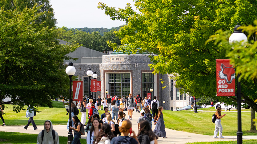Image of students walking on campus on a beautiful day.