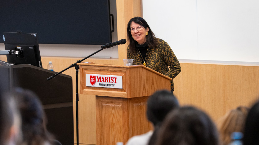 Image of Joan Murray speaking at podium.