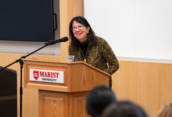 Image of Joan Murray speaking at podium.
