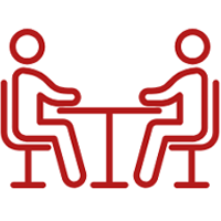 Marist University's icon of two people at a table talking representing the Center for Advising and Academic Services. 