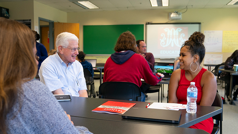 Associate Dean for Teacher Education Edward Sullivan speaking with a Beacon LEAD Scholar