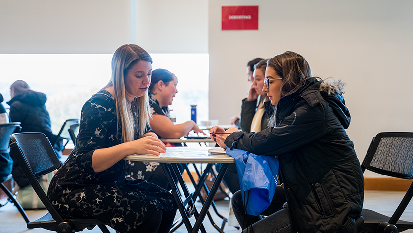 Chanel Marino works with a student at the event