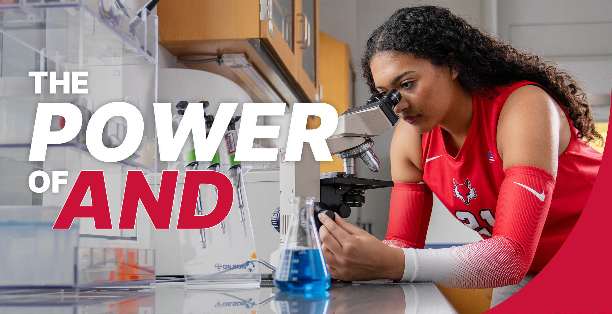 Image of Vallane Sneva looking into a microscope with "The Power of And" text overlaid.