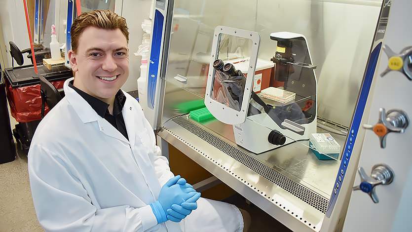 Jonathan monitors the development of human brain cells under the microscope at the Picower Institute for Learning and Memory (Tsai Laboratory), MIT. Photo courtesy of Jonathan Palmiero ’26.