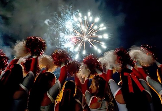 Image of Marist Cheerleading with fireworks at Marist. Photo by Carlisle Stockton. 