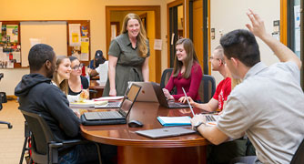 Image of students having a discussion with a professor.