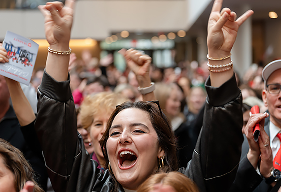 Image of attendees in the Dyson Center cheering as Marist officially becomes a University.