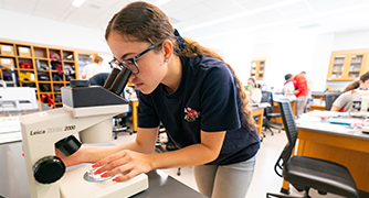 Student using microscope