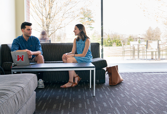 Image of two people talking. 