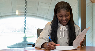 An image of a student doing paperwork. 