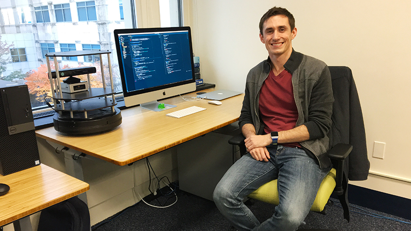 Justin Svegliato, class of 2014, at work in his lab at UMass