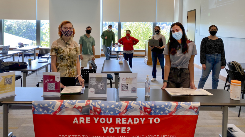Marist students at a register to vote table