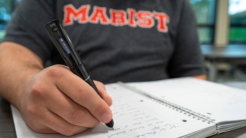 Image of student writing in notebook