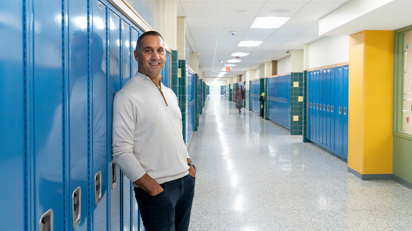 Image of John Liporace ’88 by his old locker at Hoosick Falls High School. 