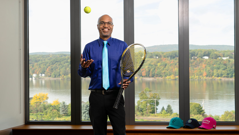 Image of Dr. Buckmire with tennis equipment. 