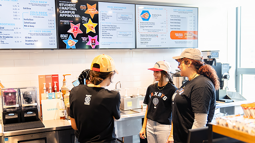 Image of Team members huddle before the grand opening of Saxbys in the Fall.