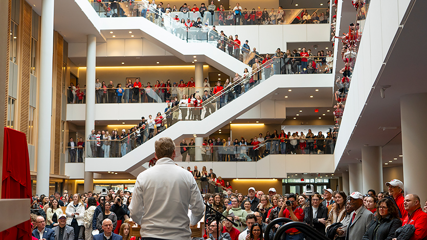 Image of President Weinman speaking to a packed Dyson Center on University Day.