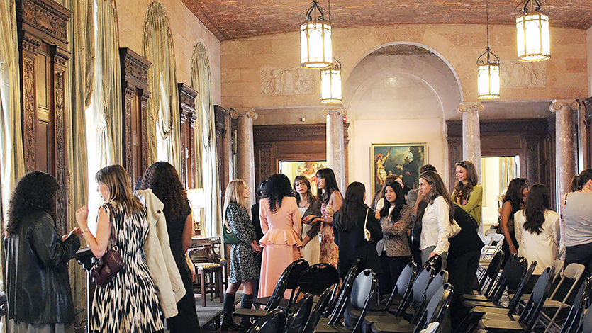 Image of Fashion students have one-on-one conversations with the four panelists after the event at the University's Payne Mansion.