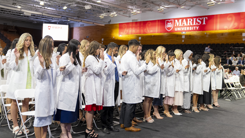Image of PA students in their white coats at their awards ceremony.