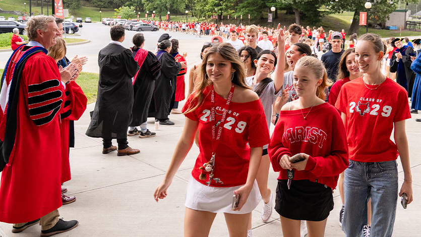 Image of President Weinman greeting first-year students.