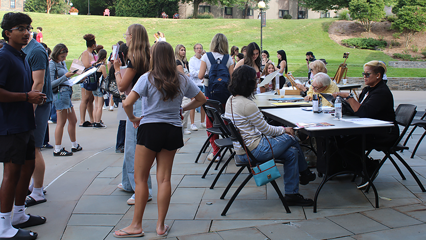 Students get caricatures of themselves by local artists at the Student Activities Fair. 