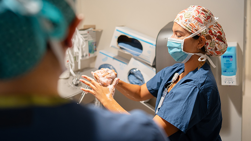 Marist Physician Assistant Student Valerie DeLeon carefully follows sterile protocols before entering a surgical suite at Vassar Brothers Medical Center. Photo by Nelson Echeverria/Marist University. 