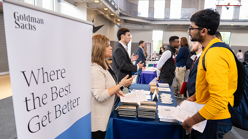 Image of student meeting an employer from Goldman Sachs at the Career and Internship Fair.