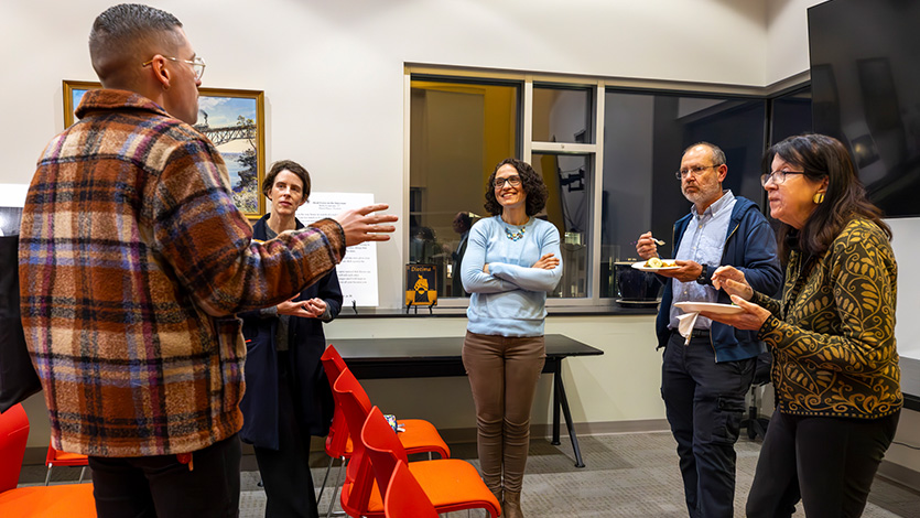 Image of Joan Murray speaking with faculty.