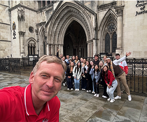 Image of President Kevin Weinman with students on a travel course in London.