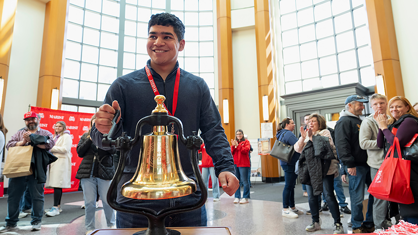 Image of student ringing the bell during an Admitted Student Day in 2024.