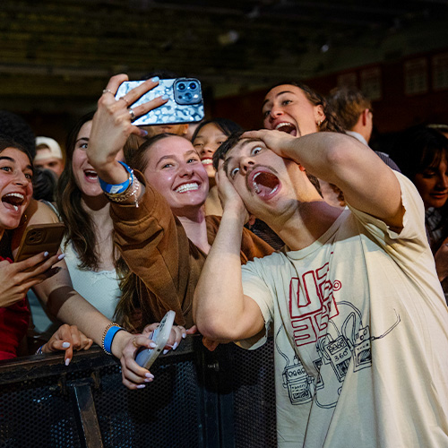 Marist University image: Performer from Laundry Day interacts with student at spring concert.