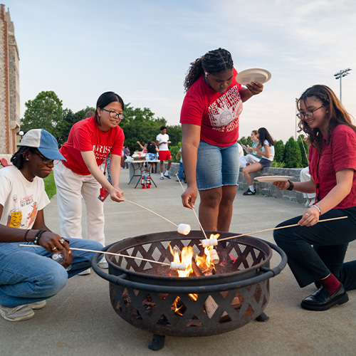 Marist University image: Students roast marshmallows near the campus green.