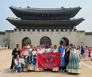 Marist University image: students pose with Marist banner in Korea.