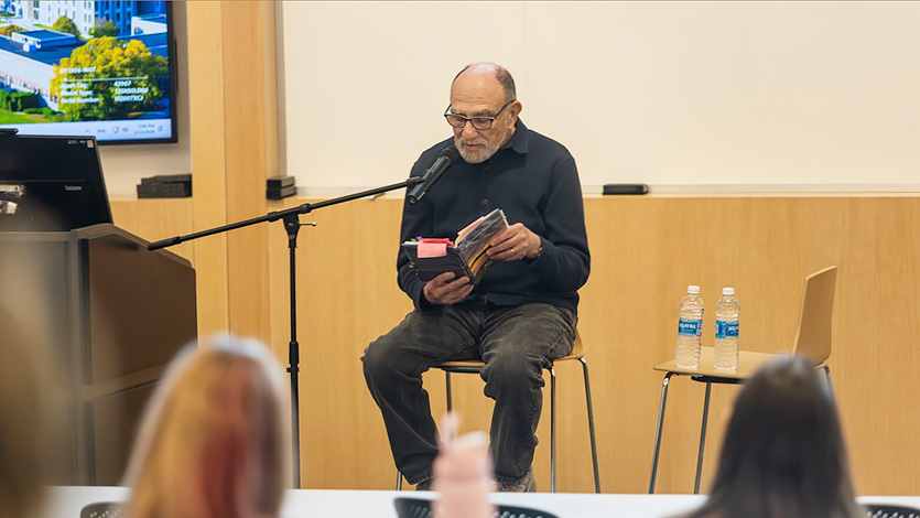 Image of Philip Schultz reading his poetry.