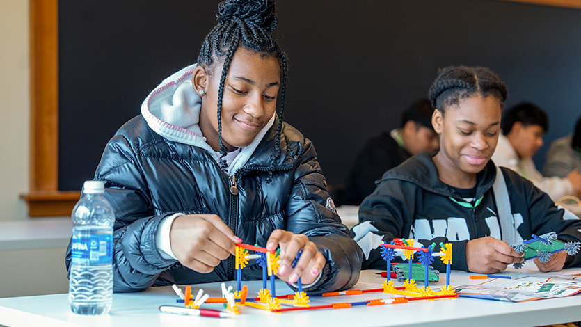 Image of students building bridges as part of a workshop at the Mind Meld event.