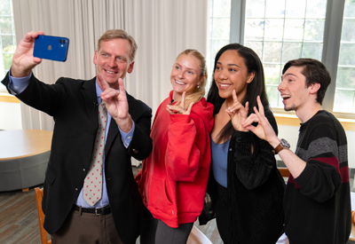 Image of Marist University President Weinman with students at a taping of Between 2 Foxes.
